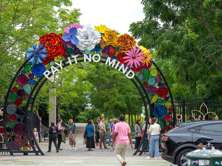 Walk beneath a floral gateway honoring an LGBTQ+ trailblazer